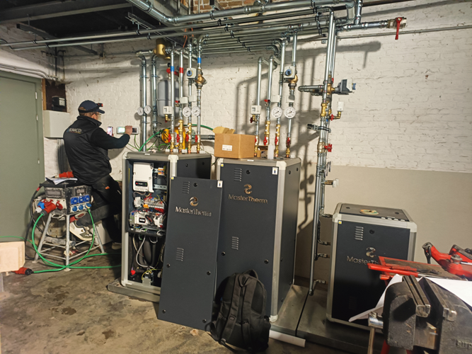 Heatco technicians deliver and connect the heat pumps.